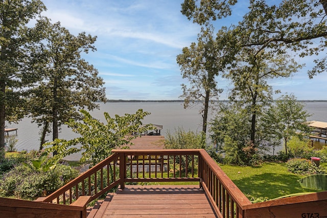 wooden deck featuring a yard and a water view