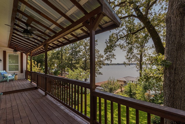 wooden deck featuring a water view and ceiling fan