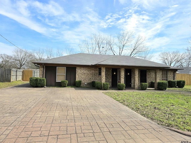 ranch-style home with fence