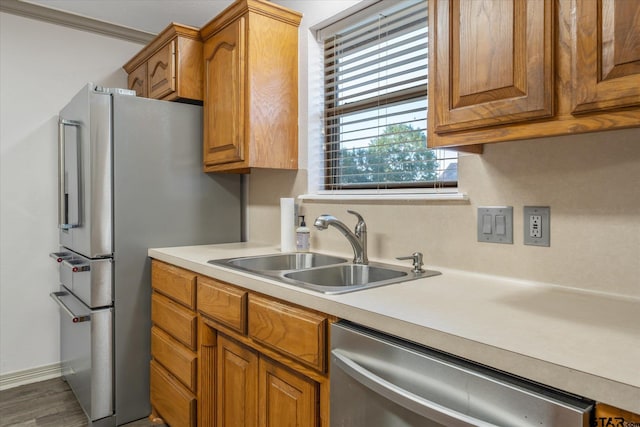 504 Susie St, Chandler, TX 75758 - kitchen with stainless steel appliances, a sink, light countertops, and brown cabinets