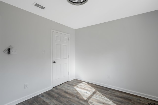 spare room with dark hardwood / wood-style flooring