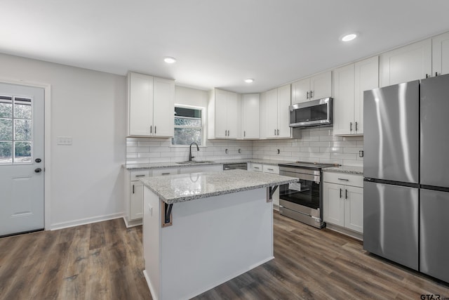 kitchen featuring sink, a center island, white cabinets, and appliances with stainless steel finishes