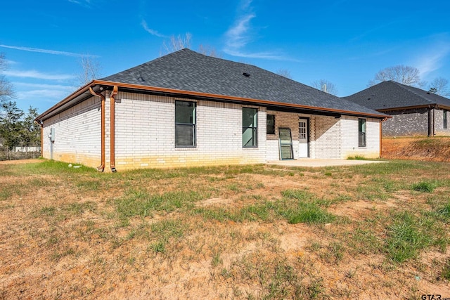 back of house featuring a yard and a patio