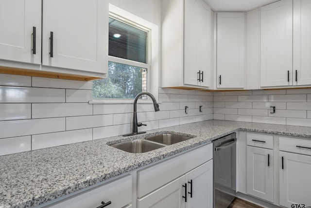 kitchen featuring white cabinetry, sink, decorative backsplash, and dishwasher