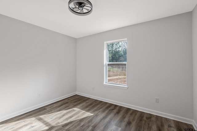 spare room featuring dark wood-type flooring