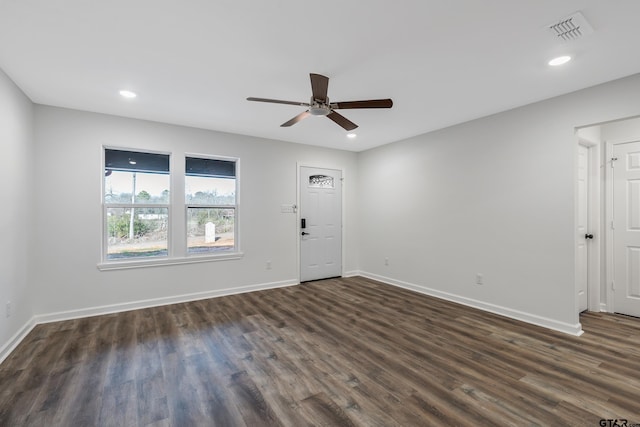 unfurnished room with dark wood-type flooring and ceiling fan