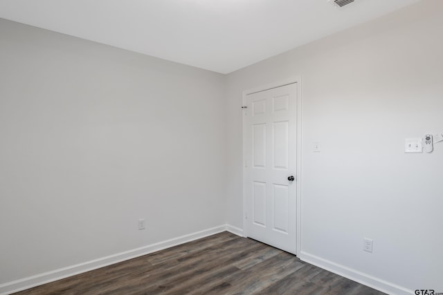 spare room featuring dark hardwood / wood-style flooring