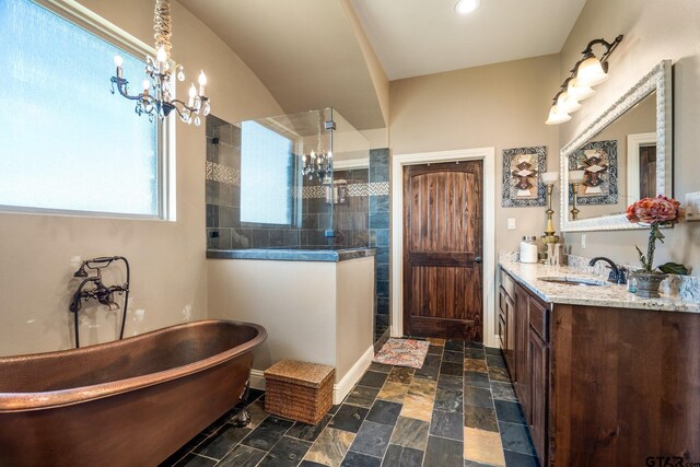 4180 N Smith Rd, Rockwall, TX 75087 - full bath with vanity, a chandelier, walk in shower, a freestanding bath, and stone tile flooring
