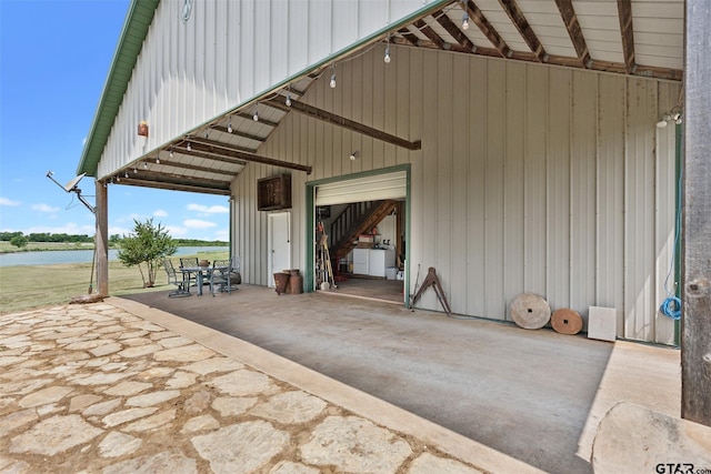 4180 N Smith Rd, Rockwall, TX 75087 - view of patio with a water view, a detached garage, and outdoor dining area