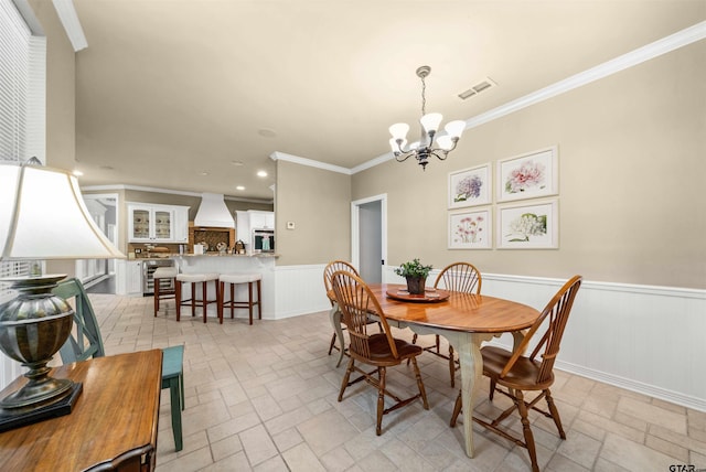 dining space with beverage cooler, a chandelier, and crown molding