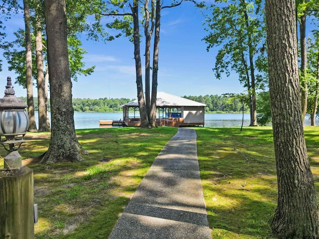 view of front of home with a water view, a front yard, and a gazebo