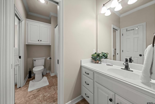 bathroom featuring toilet, vanity, and crown molding