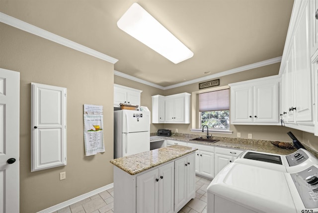 kitchen with white cabinets, sink, a kitchen island, and white refrigerator