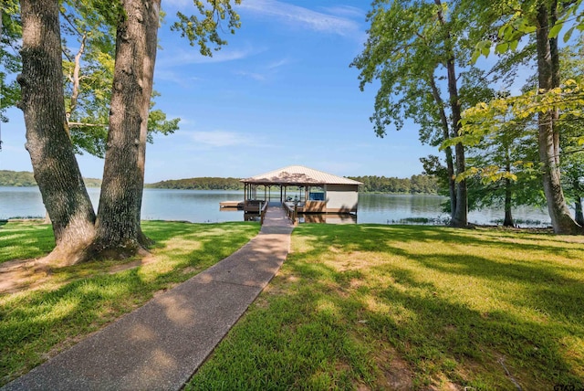 dock area featuring a lawn and a water view