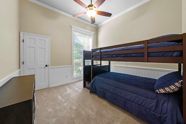 carpeted bedroom featuring ceiling fan, multiple windows, and ornamental molding