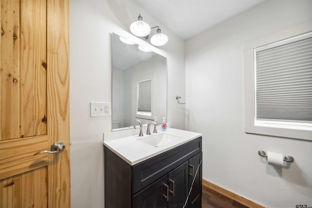 bathroom featuring vanity, toilet, and wood-type flooring