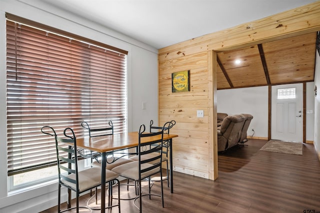 dining room with dark hardwood / wood-style flooring, wooden walls, wooden ceiling, and vaulted ceiling