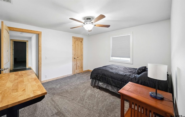 bedroom featuring ceiling fan and dark carpet