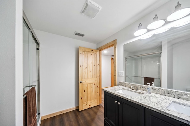 bathroom with vanity, hardwood / wood-style floors, and an enclosed shower