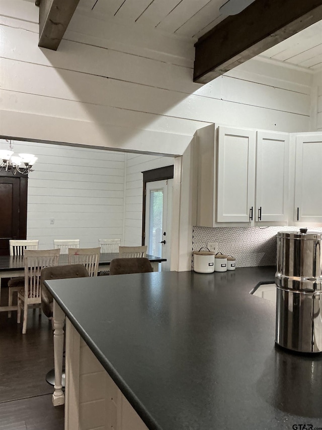 500 W Main St, Mount Vernon, TX 75457 - kitchen featuring a kitchen breakfast bar, dark countertops, a chandelier, white cabinetry, and beamed ceiling