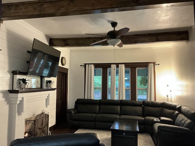 500 W Main St, Mount Vernon, TX 75457 - living room featuring a ceiling fan, wood finished floors, beam ceiling, and a fireplace