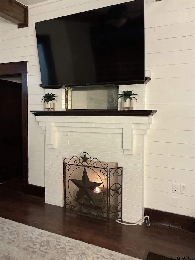 500 W Main St, Mount Vernon, TX 75457 - room details featuring wood walls, a brick fireplace, and wood finished floors