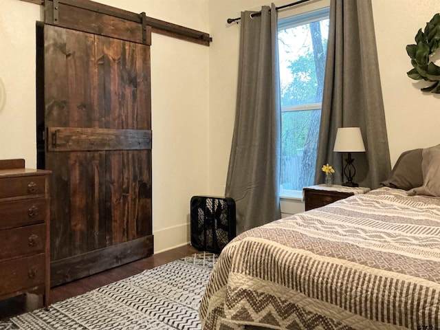 500 W Main St, Mount Vernon, TX 75457 - bedroom with dark wood-type flooring and a barn door