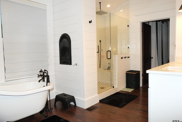 500 W Main St, Mount Vernon, TX 75457 - full bathroom with wood finished floors, a stall shower, vanity, a freestanding tub, and visible vents