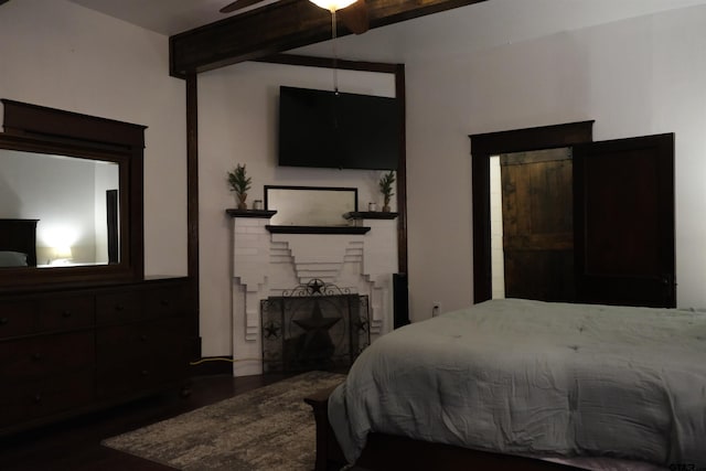 500 W Main St, Mount Vernon, TX 75457 - bedroom featuring a brick fireplace, wood finished floors, and beam ceiling