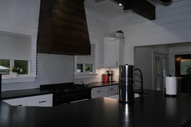 500 W Main St, Mount Vernon, TX 75457 - kitchen featuring black range with gas stovetop, dark countertops, tasteful backsplash, and white cabinetry