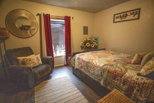 bedroom with multiple windows and dark hardwood / wood-style flooring