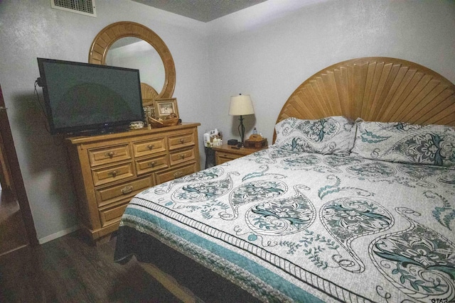 bedroom featuring dark hardwood / wood-style floors