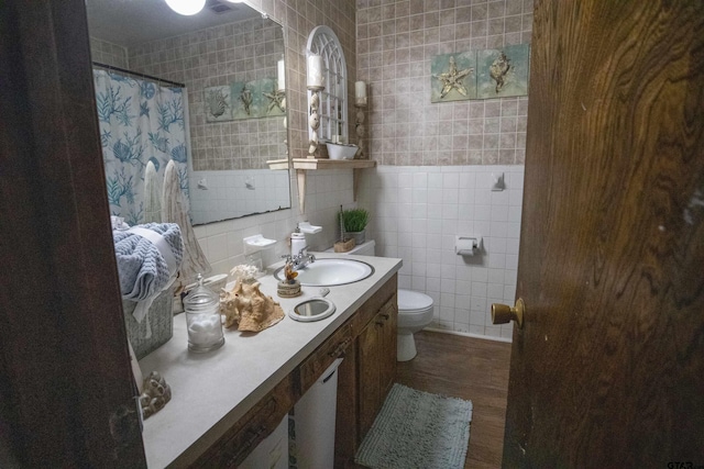 bathroom featuring curtained shower, vanity, tile walls, toilet, and hardwood / wood-style flooring