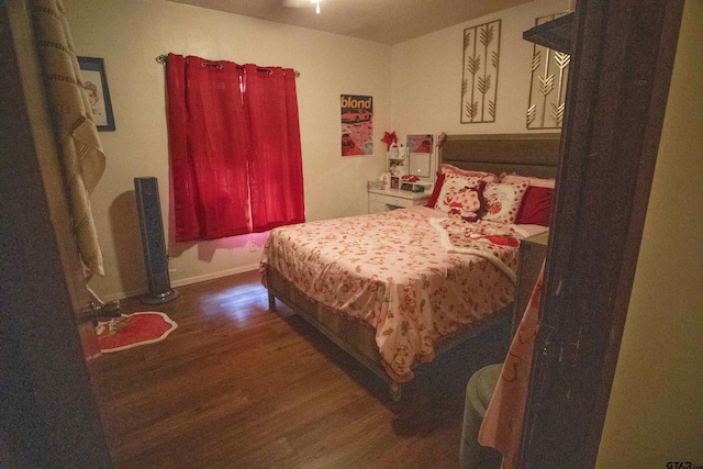 bedroom with dark hardwood / wood-style flooring