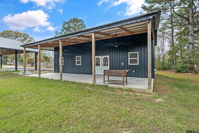back of property featuring a patio, french doors, a ceiling fan, a lawn, and board and batten siding