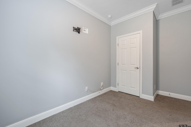 unfurnished room featuring crown molding, carpet, baseboards, and visible vents