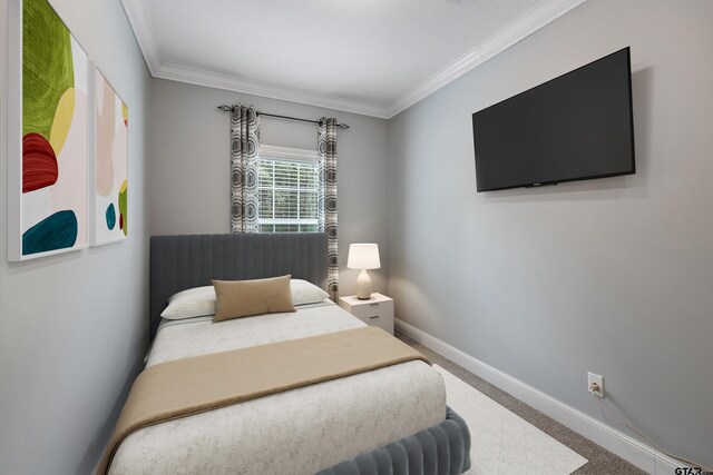 carpeted bedroom featuring baseboards and ornamental molding