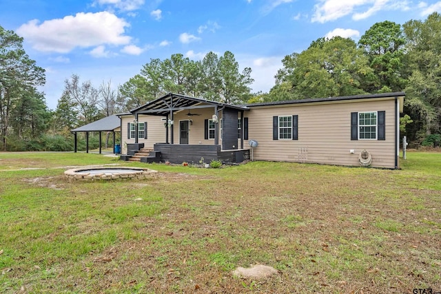 view of front facade featuring a wooden deck, a front lawn, and a jacuzzi