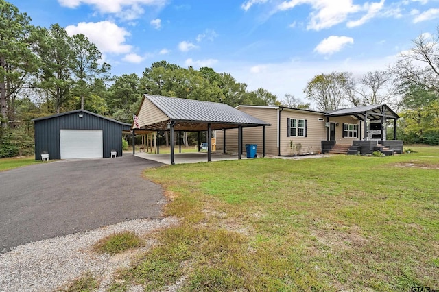 single story home featuring driveway, an outdoor structure, a front lawn, and a garage
