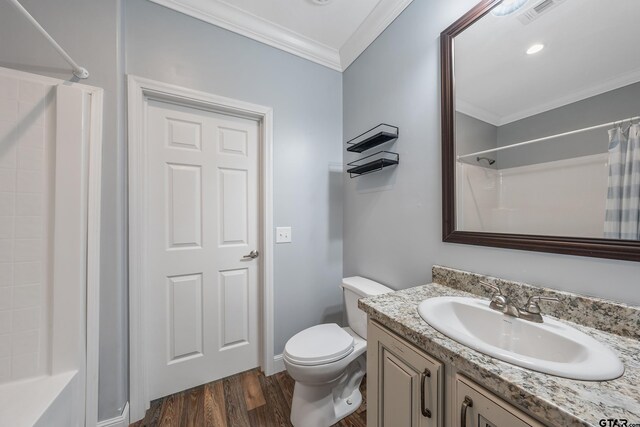 bathroom with a shower with curtain, ornamental molding, vanity, and wood finished floors