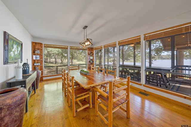 sunroom featuring a water view and a wealth of natural light