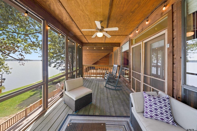 sunroom / solarium with wood ceiling, ceiling fan, a water view, and a healthy amount of sunlight