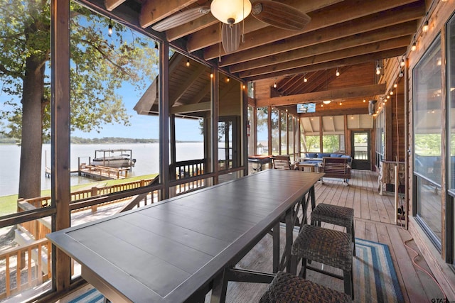 sunroom featuring vaulted ceiling with beams, a water view, and ceiling fan