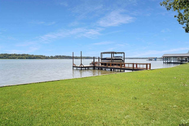 view of dock with a water view and a yard