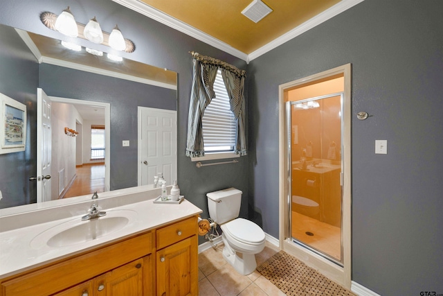 bathroom with tile patterned floors, walk in shower, vanity, crown molding, and toilet