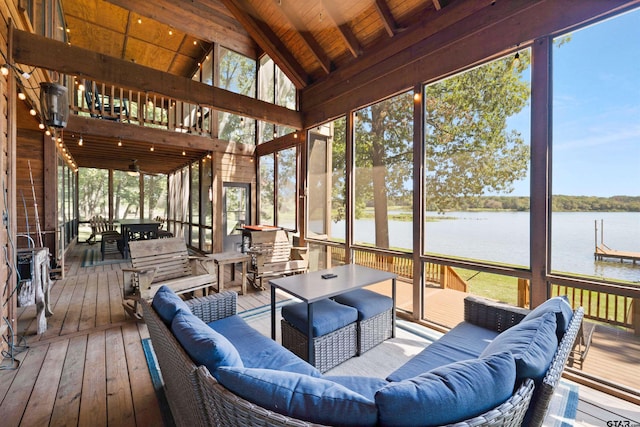 sunroom featuring a water view, plenty of natural light, and wood ceiling