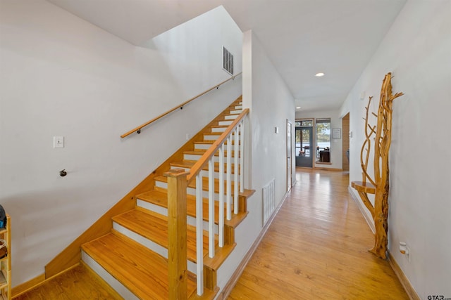 staircase featuring wood-type flooring