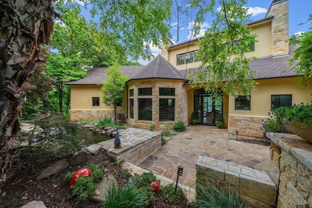 back of property with a patio area and french doors