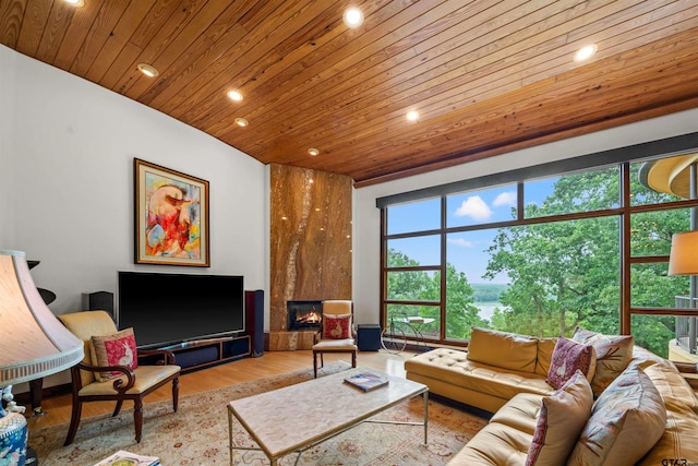 living room featuring a large fireplace, light hardwood / wood-style flooring, and wood ceiling