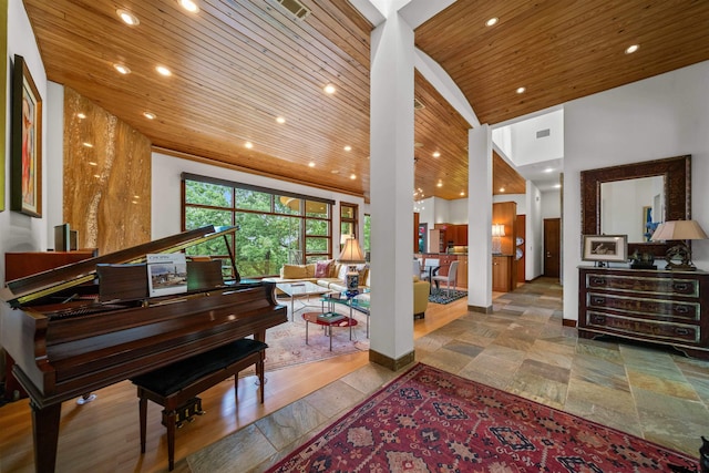 misc room with high vaulted ceiling and wooden ceiling